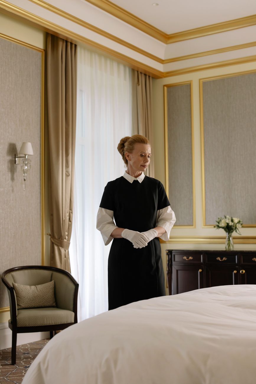 woman standing beside the bed